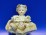 Kisméretű porcelán testű baba